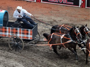 Layne Bremner hits a barrell and then had some horses get tangled up  and he had to pull his team over just after the first corner in heat six at the Rangeland Derby  Chuckwagon races on Saturday, July 4, 2015 at the Calgary Stampede.