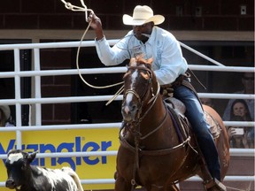 Fred Whitfield from Texas wins the day at the tie-down roping championship at the Calgary Stampede on Tuesday.