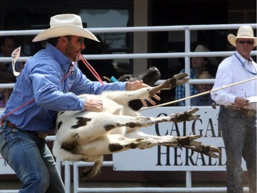 Cade Swor from Texas during the tie-down roping championship at the Calgary Stampede in Calgary, on July 7, 2015.