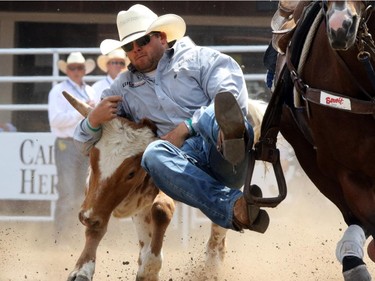 Jesse Lawes from Provost, Alberta during the steer wrestling championship at the Calgary Stampede in Calgary, on July 7, 2015.