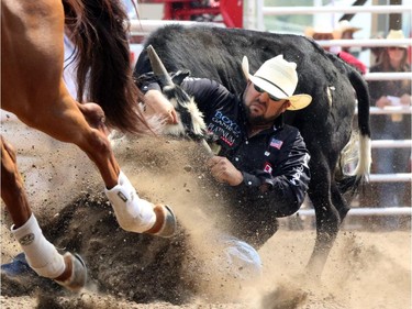 Ty Erickson from Montana during the steer wrestling championship at the Calgary Stampede in Calgary, on July 7, 2015.