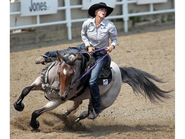 Sarah Rose McDonald takes a corner in Barrel Racing at the Calgary Stampede Rodeo Wednesday July 9, 2015.