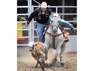 Clint Robinson  of Spanish Fork, Utah competes in Tie-Down roping at the Calgary Stampede Rodeo Wednesday July 9, 2015.