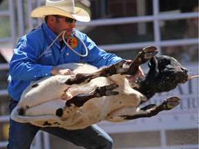 Hunter Herrin competes in the tie-down roping event during day 1 of the Calgary Stampede rodeo on  Friday July 3, 2015.
