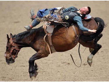 Orin Larsen of Inglis, Manitoba rides Mile Away during the Bareback competition at the Calgary Stampede Rodeo Wednesday July 9, 2015.