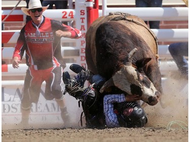 Bull rider Trey Benton III has a close call with Wrangler Extreme during the Calgary Stampede Bull Riding Championship.