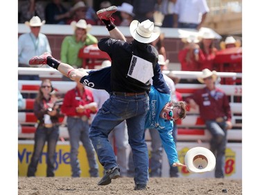 CALGARY.;  July 10, 2015, 2015  -- Luke Branquinho from Los Alamos, California spins rodeo clown Flint Rasmussen after his ride during the Calgary Stampede Steer Wrestling  Championship. Photo Leah Hennel/Calgary Herald