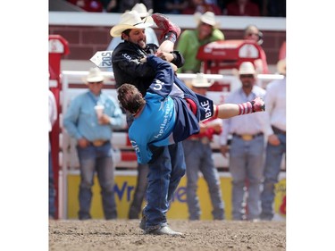 CALGARY.;  July 10, 2015, 2015  -- Luke Branquinho from Los Alamos, California spins rodeo clown Flint Rasmussen after his ride during the Calgary Stampede Steer Wrestling  Championship. Photo Leah Hennel/Calgary Herald