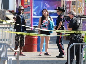 Police investigate the scene of an a stabbing on the Calgary Stampede Midway.