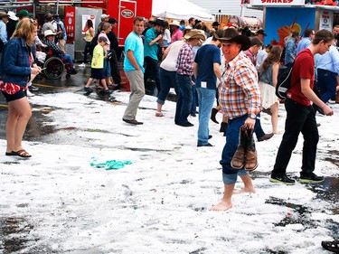 A severe thunderstorm dumped heavy rain and hail on the Calgary Stampede grounds resulting in people navigating through accumulations in Calgary, Alberta on July 4.