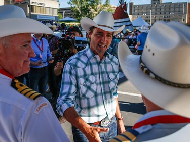 Liberal Leader Justin Trudeau greets spectators during the Calgary Stampede parade in Calgary, Friday, July 3.
