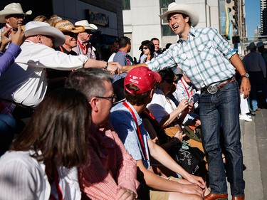 Liberal Leader Justin Trudeau greets spectators during the Calgary Stampede parade in Calgary, Friday, July 3.