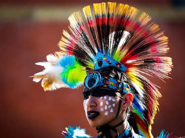 A member of the Stoney First Nation wears a headdress during the Calgary Stampede parade in Calgary, Friday, July 3, 2015.