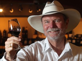 Joel Peterson, one of the wealthiest Americans and the godfather of Zin, holds a glass of his Ravens Wood wine Thursday July 10, 2015 during a tasting event at The Cellar Wine Store in Calgary.