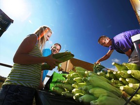 Brad Jensen and his wife Becky, along with employee Austin Rausch, right, prepare Taber corn in the Totem parking lot in Airdrie on Saturday Sept. 1, 2012.