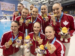Calgarians Gabrielle Brisson and Claudia Holzner and the rest of Team Canada show off their gold medals after winning the Synchronized Swimming Team event at the Pan Am Games on Saturday.