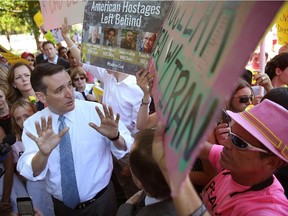 Republican presidential candidate, U.S. Sen. Ted Cruz debates members of the protest group Code Pink while speaking about the Iran nuclear deal during a rally in Washington, D.C.