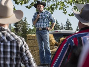 Wildrose leader Brian Jean addresses a crowd of supporters from the back of a pickup truck at the Wildrose Stomp Stampede BBQ in Calgary, on July 2, 2015.
