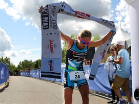 Magali Tisseyre crosses the finish line with a top ladies time during the Ironman 70.3 Calgary at Auburn Bay on July 26, 2015. Tisseyre was later disqualified.