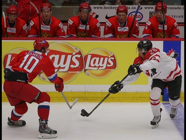 Team Russia player Nikita Lyamkin, left, sweeps in to block Team Canada player Joshua Ho-Sang's shot in the opening game of the World's Junior Showcase at the Markin MacPhail Centre in Calgary on Monday, Aug. 3, 2015. Team Canada was tied with Team Russia, 1-1, at the end of the first period.
