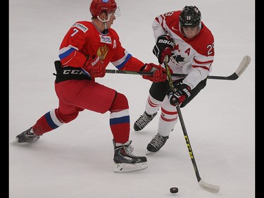 Team Russia player Evgeny Svechnikov, left, puts his stick out to block the approach of Team Canada player Robby Fabbri in the opening game of the World's Junior Showcase at the Markin MacPhail Centre in Calgary on Monday, Aug. 3, 2015. Team Canada was tied with Team Russia, 1-1, at the end of the first period.