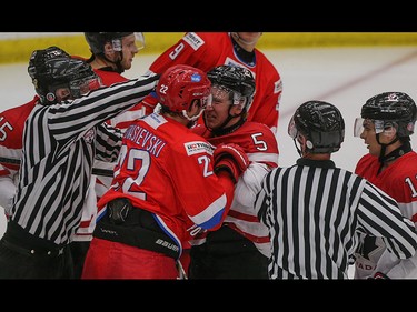 Team Russia player Semen Afonasyevskiy, centre left, goes face to face with Team Canada player Travis Dermott in the opening game of the World's Junior Showcase at the Markin MacPhail Centre in Calgary on Monday, Aug. 3, 2015. Team Canada led over Team Russia, 3-1, at the end of the second period.