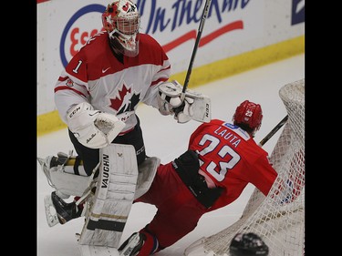 In a heated second period, Team Canada goalie Mason McDonald knocks Team Russia player Artur Lauta into the net for getting into his space in the opening game of the World's Junior Showcase at the Markin MacPhail Centre in Calgary on Monday, Aug. 3, 2015. Team Canada led over Team Russia, 3-1, at the end of the second period.