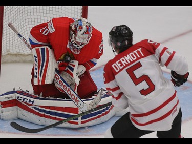 Team Russia goalie Maxim Tretyak saves a shot on net by Team Canada player Travis Dermott in the opening game of the World's Junior Showcase at the Markin MacPhail Centre in Calgary on Monday, Aug. 3, 2015. Team Canada won over Team Russia, 4-1.