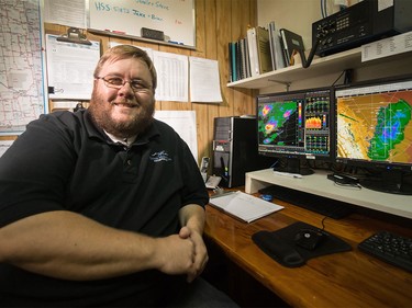 Dan Gilbert, chief meteorologist for Weather Modification Inc., sits in the weather monitoring room in front of screens showing the hail cloud maps for Calgary, in Olds on Thursday, Aug. 6, 2015.