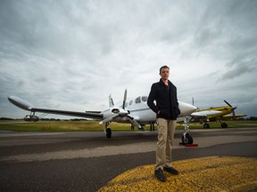 Andrew Brice, captain and pilot for Weather Modification Inc., stands in front of a Cessna 340 used for cloud seeding to prevent hail, at the Olds Airport on Thursday, Aug. 6, 2015.