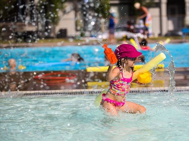 Kirsi Doucher, 5, enjoys some pool toys at Bowview Outdoor Pool in Calgary on Monday, Aug. 10, 2015.