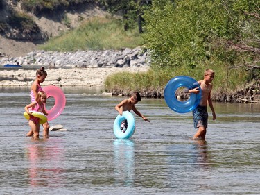 Calgarians are hit with a heat wave as they knuckle down for the dog days of summer like Jack Wesolowski, 14, Wyatt, 7, Gabrielle, 14, and Chloe, 5, as they enjoy the water at Sandy Beach in Calgary on August 11, 2015.