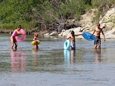 Children enjoy the water at Sandy Beach in Calgary on August 11, 2015.