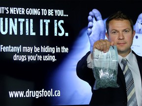 Staff Sgt. Martin Schiavetta of the CPS Drug Unit holds some fentanyl during a press conference at CPS headquarters in Calgary on August 13, 2015.