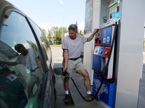 Dan Roach fills up at Esso gas station at Silver Springs in Calgary on August 13, 2015.