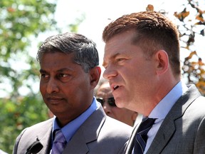 WIldrose leader Brian Jean talks about the issues facing voters this by-election as Calgary-Foothills candidate Prasad Panda looks on, in Calgary on August 13, 2015.