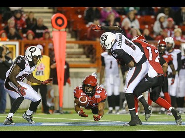 Calgary Stampeders running back Keith Toston, centre, leaps to catch a Ottawa Redblacks fumble at McMahon Stadium in Calgary on Saturday, Aug. 15, 2015. The Calgary Stampeders won over the Ottawa Redblacks, 48-3, in regular season CFL play.
