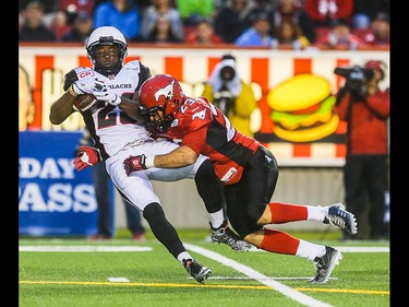 Ottawa Redblacks running back Chevon Walker, left, is taken out by Calgary Stampeder running back William Langlais at McMahon Stadium in Calgary on Saturday, Aug. 15, 2015. The Calgary Stampeders led the Ottawa Redblacks, 31-3, at the half in regular season CFL play.