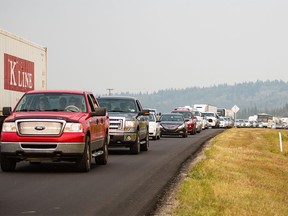 A long line of vehicles slowly inching along Highway 1 after a multiple vehicle collision between a van and a semitrailer near Morley on Monday, Aug. 24, 2015.
