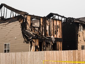 The remains of the second floor of two homes gutted by an afternoon fire in the community of Panorama Hills in Calgary on Tuesday, Aug. 25.