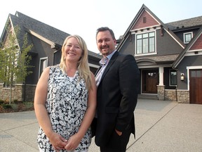 Calgary Health Trust Manager of Events and Lotteries Nicole Janke, left, and Calbridge Homes Director of Marketing Dan Hippe stood outside the 2015 Hospital Home Lottery prize home in Mahogany on August 26, 2015.