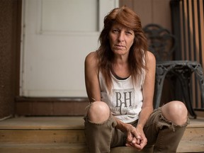 Karen Casey sits in her home on Edmonton Trail in Calgary on Wednesday, Aug. 26, 2015. Casey, who has early onset Parkinson's and cervical cancer, is furious the City of Calgary has asked for her 18 year old son's financial information in order to receive a discounted recreation pass.