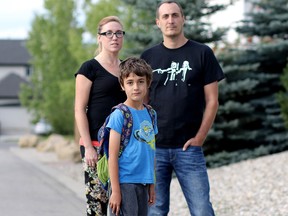 Cathy Watkins and Andy Lemminger are upset that their seven-year-old son Niklas has to walk 8 km along Stoney Trail and the TransCanada Highway to attend his German bilingual school in Calgary.