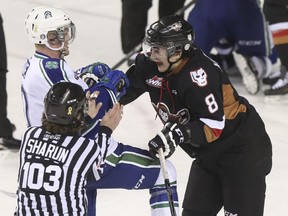 Loch Morrison, right, seen mixing it up with Swift Current's Colby Cave during a game last season, topped all Hitmen players in the bench press, with 29 reps at 155 pounds.