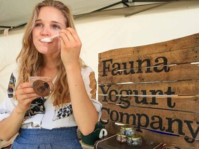 Christina Sisson samples some of her homemade cocoa yogurt at the Bridgeland farmers market.