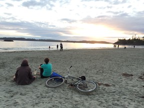 Beachgoers with their sand-friendly bike in Tofino, B.C.