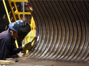 A worker welds pipes together for a steam generator used in SAG-D bitumen recovery at Babcock & Wilcox Canada's Cambridge, Ontario manufacturing plant.
