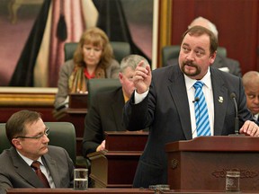 Former Alberta finance minister Lloyd Snelgrove, pictured delivering the 2011-2012 provincial budget in the Alberta legislature.