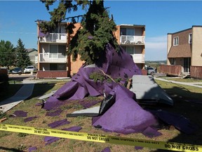 The roof of an apartment building at 1820 14th Ave. N.E. lies in a nearby green space after it was torn off in a violent thunderstorm on Tuesday.
