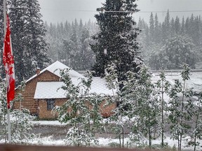 Snow falling west of Calgary at Camp Cadicasu on Friday afternoon, Aug. 21, 2015.